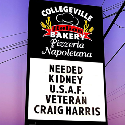 A sign at Collegeville Bakery that displays " Needed Kidney U.S.A.F Veteran Craig Harris."